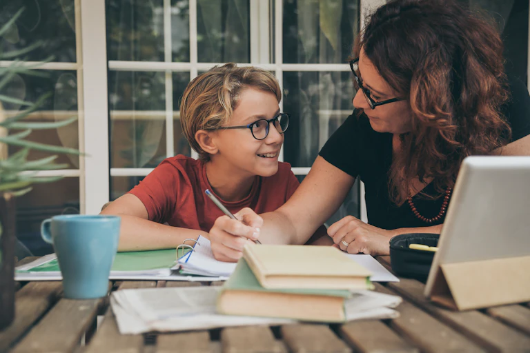 Mother homeschooling her young son.