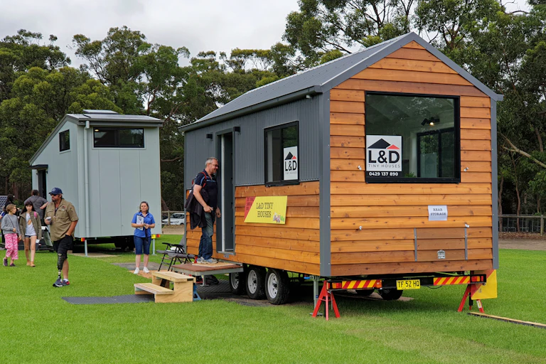 people inspecting a tiny house