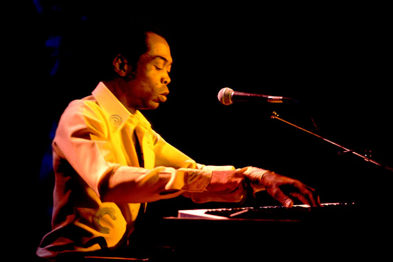 A man sitting and playing a piano