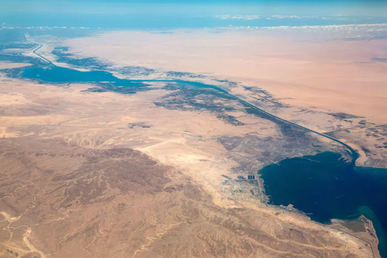 An aerial view of the Suez Canal with desert on either side.