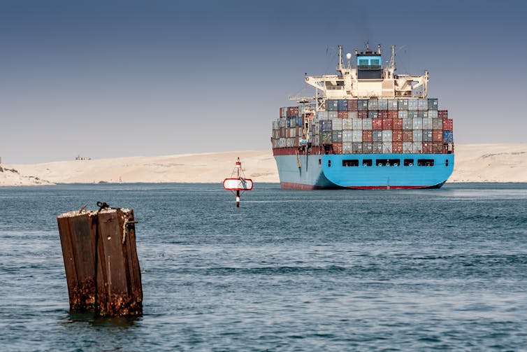 A large container vessel sailing the Suez Canal.
