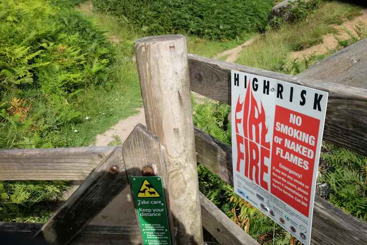 A sign on a fence that says