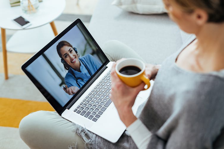 A woman video chatting with a health professional.