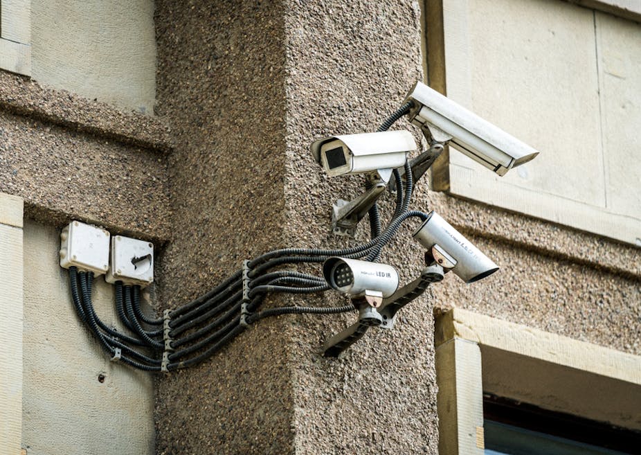 Four security cameras fixed to a wall, pointing left and right