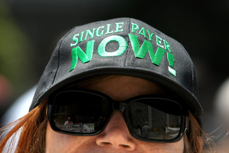 A woman wearing a hat that says