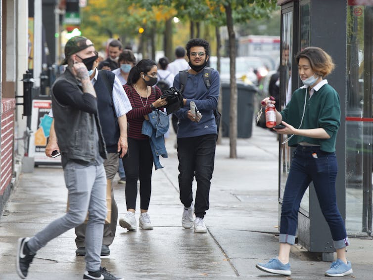People are seen on St. Catherine Street in Montreal