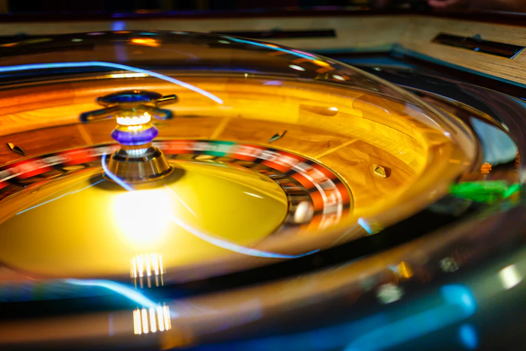 A ball moves across a roulette wheel