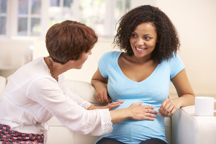 Midwife talking to pregnant woman