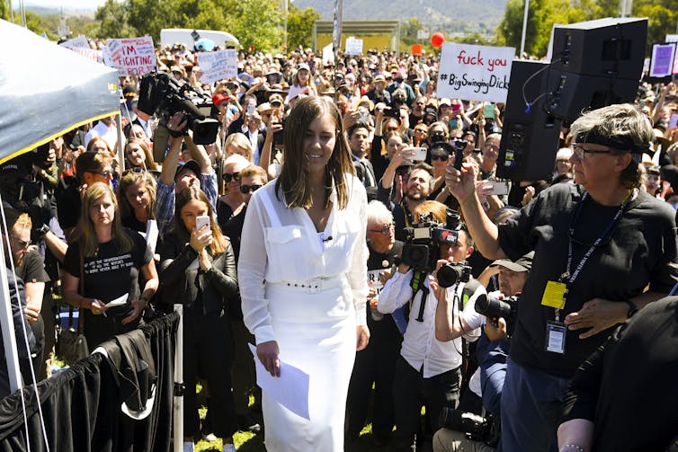 Higgins in front of a crowd of protesters.