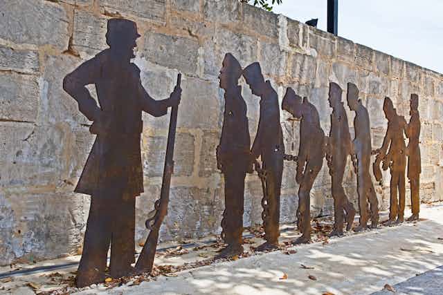 Sculpture of convicts in silhouette