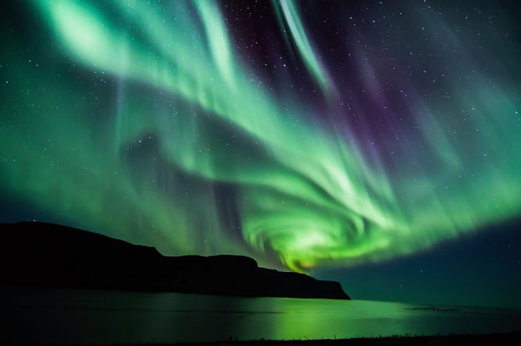 The northern lights over a lake.