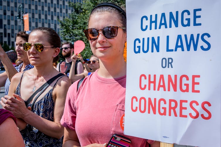 'Change gun laws or change Congress' reads a sign at a 2018 rally in New York City.