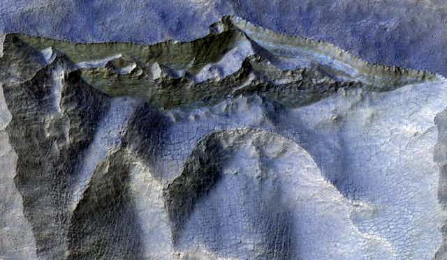 Cliffs encased in ancient ice on Mars.