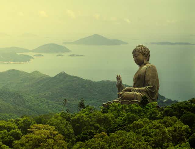 Hong Kong, Lantau Island Giant Buddha of Po Lin Monastery far away view during sunrise
