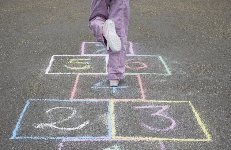 Child on hopscotch grid