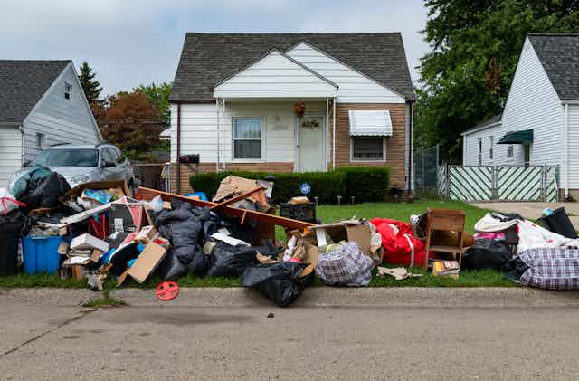 Home in Detroit with belongings piled outside
