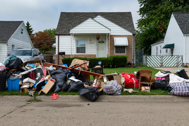 Home in Detroit with belongings piled outside