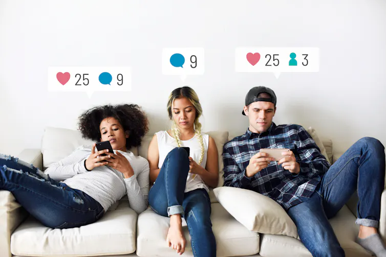 Three young people sitting on a sofa using phones with social media notification graphics over their heads