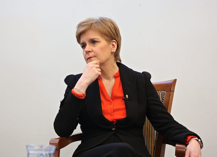 Nicola Sturgeon sitting down looking pensive