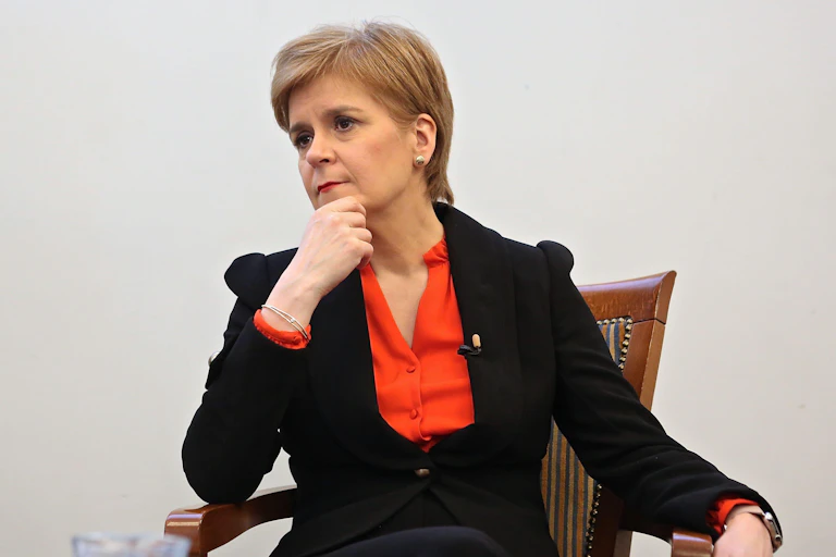 Nicola Sturgeon sitting down looking pensive