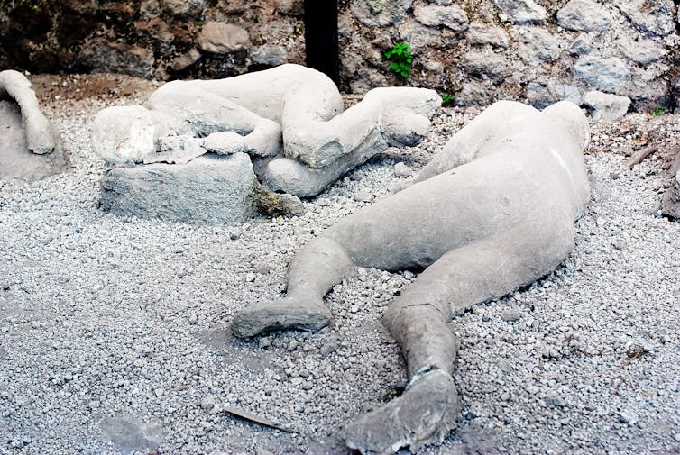 Two plaster casts of victims of the Vesuvius eruption in Pompeii.
