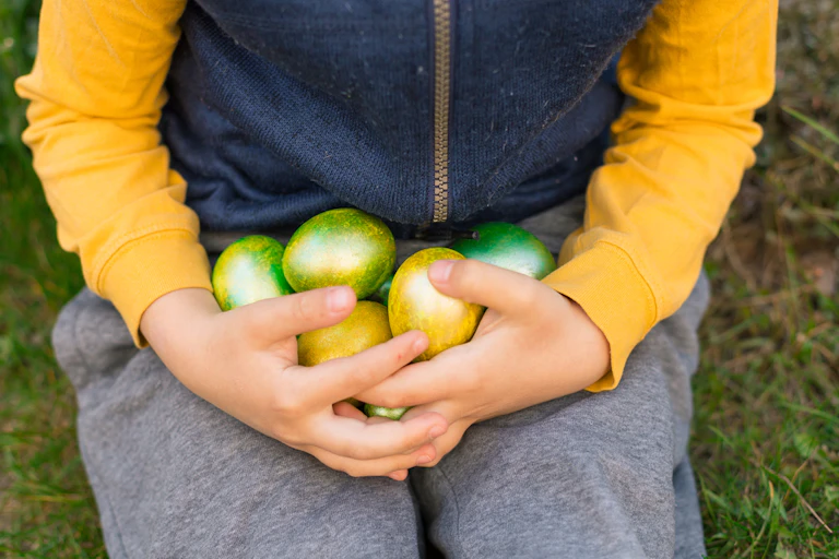 Boy clutching Easter eggs