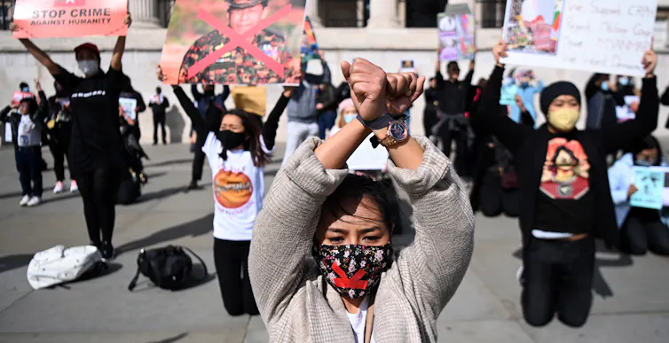 Protesters stage demonstration for Myanmar outside Britain's parliament in London, 27 March 2021.