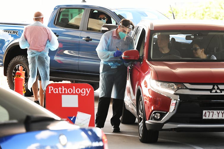 People queue at a COVID-19 drive-through testing site in Brisbane.