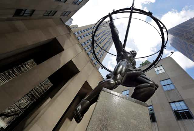 A statue of Greek god atlas stands in the shadow of Rockefeller Center in New York City