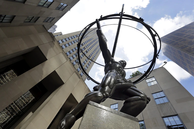 A statue of Greek god atlas stands in the shadow of Rockefeller Center in New York City