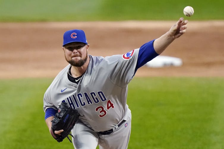 A baseball pitcher throwing the ball with his left handed