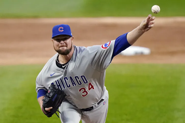 A baseball pitcher throwing the ball with his left handed