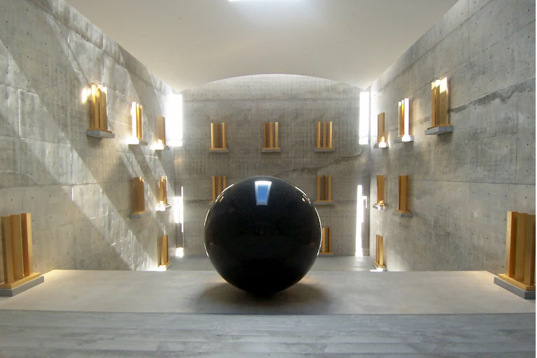 Black orb in light filled room