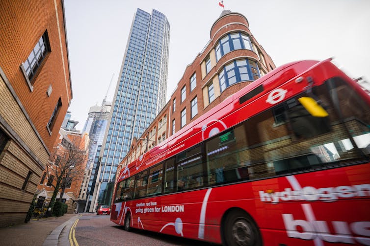 Red bus with skyscraper in background