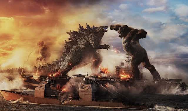 Godzilla and Kong fighting on a large ship.