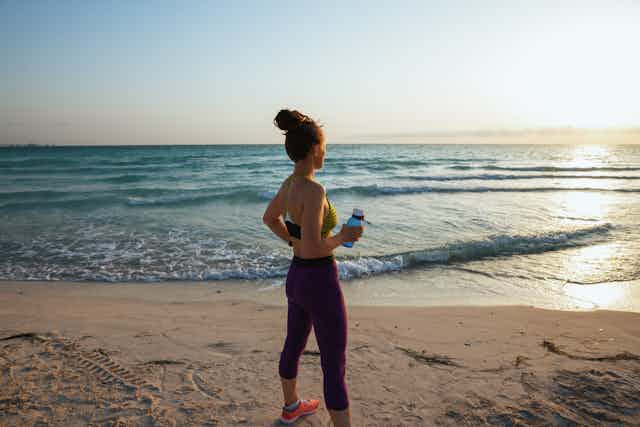 woman in activewear on beach