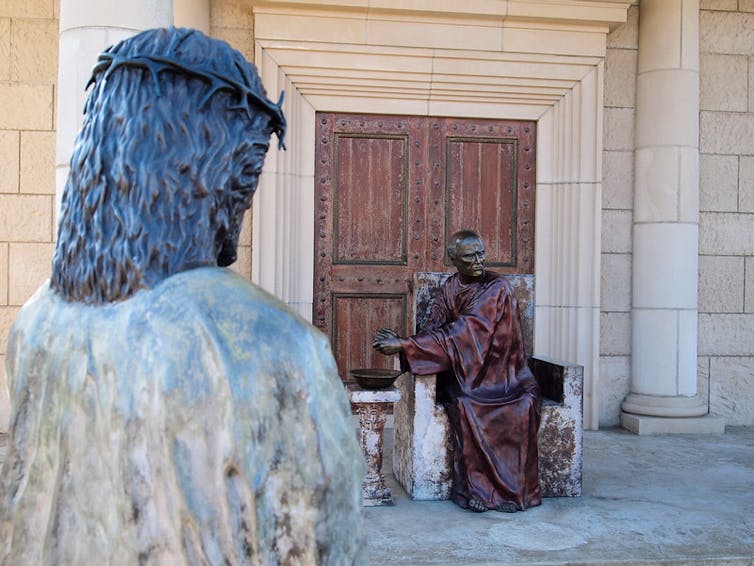 Statue of Jesus in front of Pilate washing his hands.