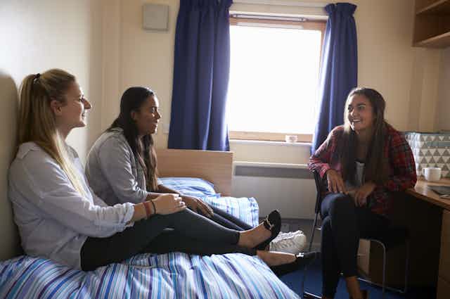 female students chatting in a dorm room