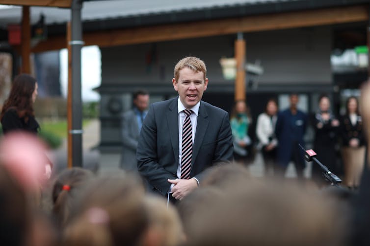 Education Minister Chris Hipkins speaking to a group of people