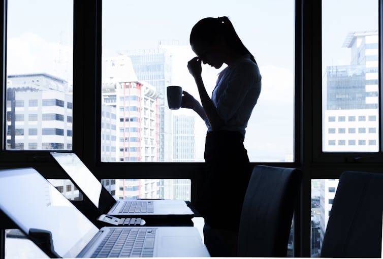 Woman stressed and isolated at work