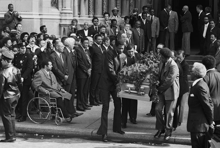 Jackie Robinson's casket being carried from a church.