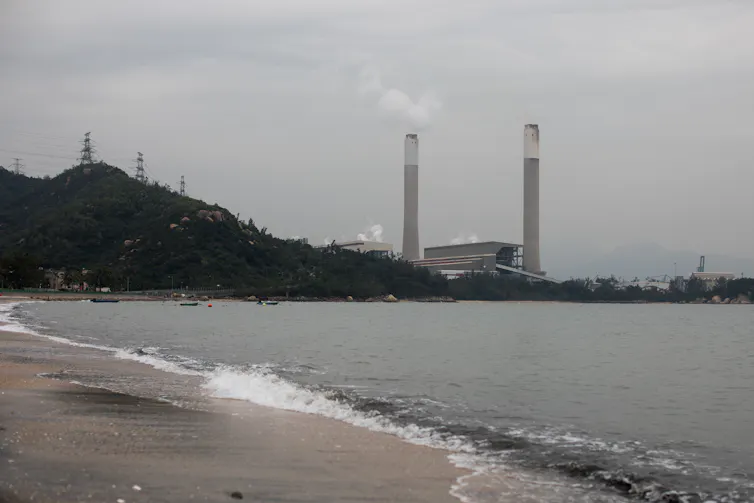 A coal-fired power station belches smoke in a Chinese bay.