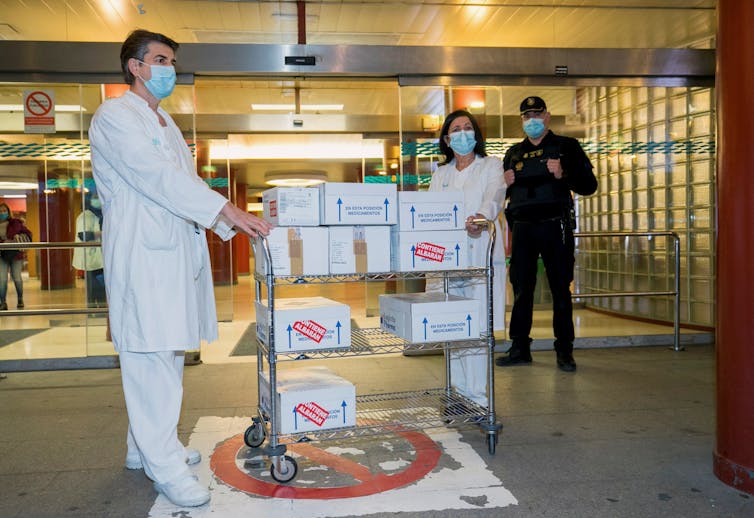 Health workers receive boxes of the AstraZeneca vaccine at University Clinico Hospital in Zaragoza, Spain.