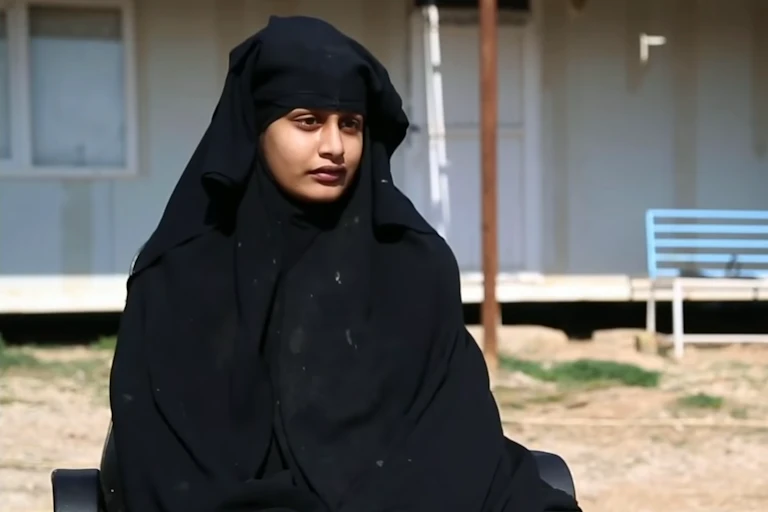 Shamima Begum wearing black and sitting in the sun