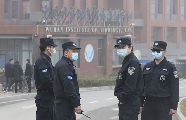 Masked security guards outside the Wuhan Institute of Virology