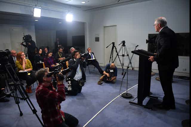 Scott Morrison gives a press conference in a media briefing room