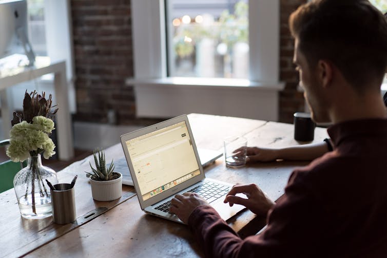 Man at desk working on laptop