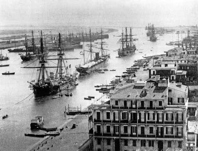 Shipping in the Suez canal at Port Said about 1880. The canal can be seen stretching southwards from this north entrance.