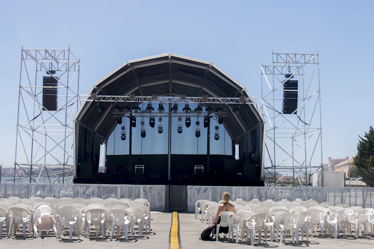 One person sitting in front of an empty stage