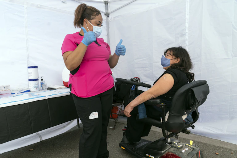 Woman in wheelchair ready to be vaccinated